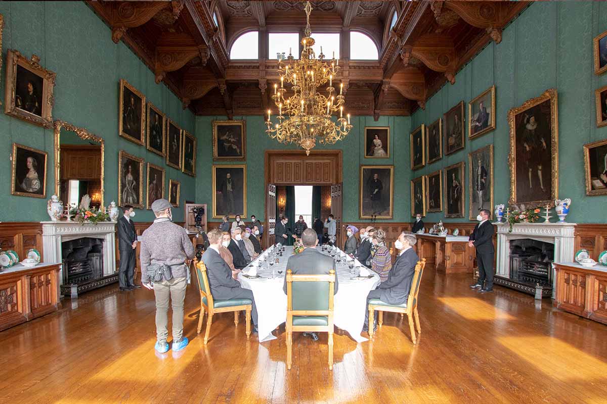 Actors sitting at a table for a filming scene for Ipcress Files at Knowsley Hall.