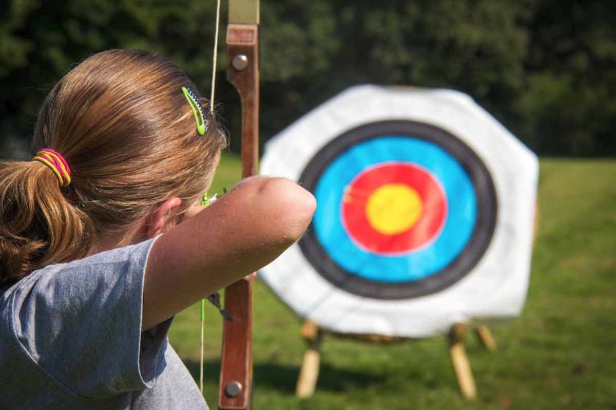 The back of a person doing archery