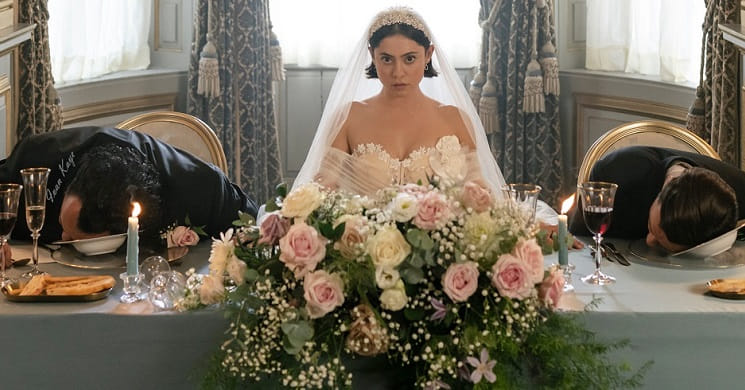 An actress sitting in a wedding dress at a dining table with a man acting dead next to her for a filming scene for Disney's Wedding Season at Knowsley Hall.