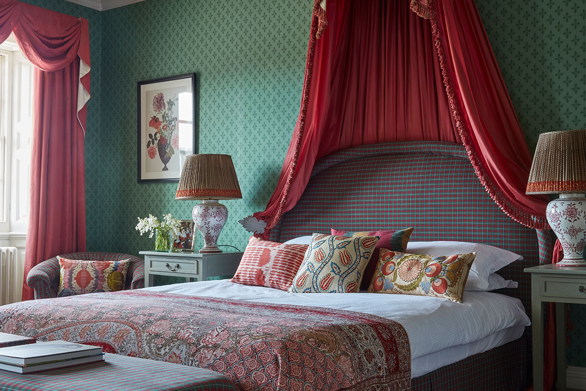 Luxury bedroom at Knowsley Hall, with beautiful soft furnishings dressing the king size bed and side lamps on either side of the bed