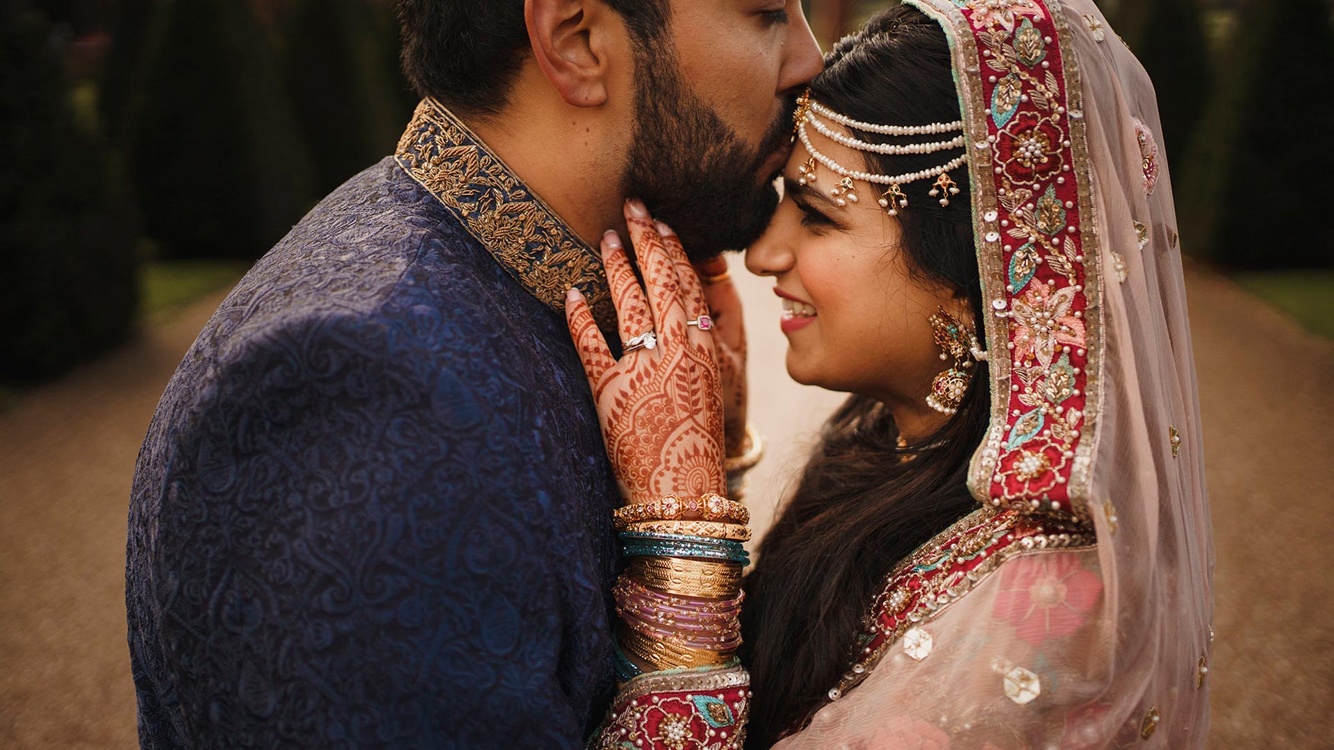 Indian Bride and Groom embracing on their wedding day at Knowsley Hall.