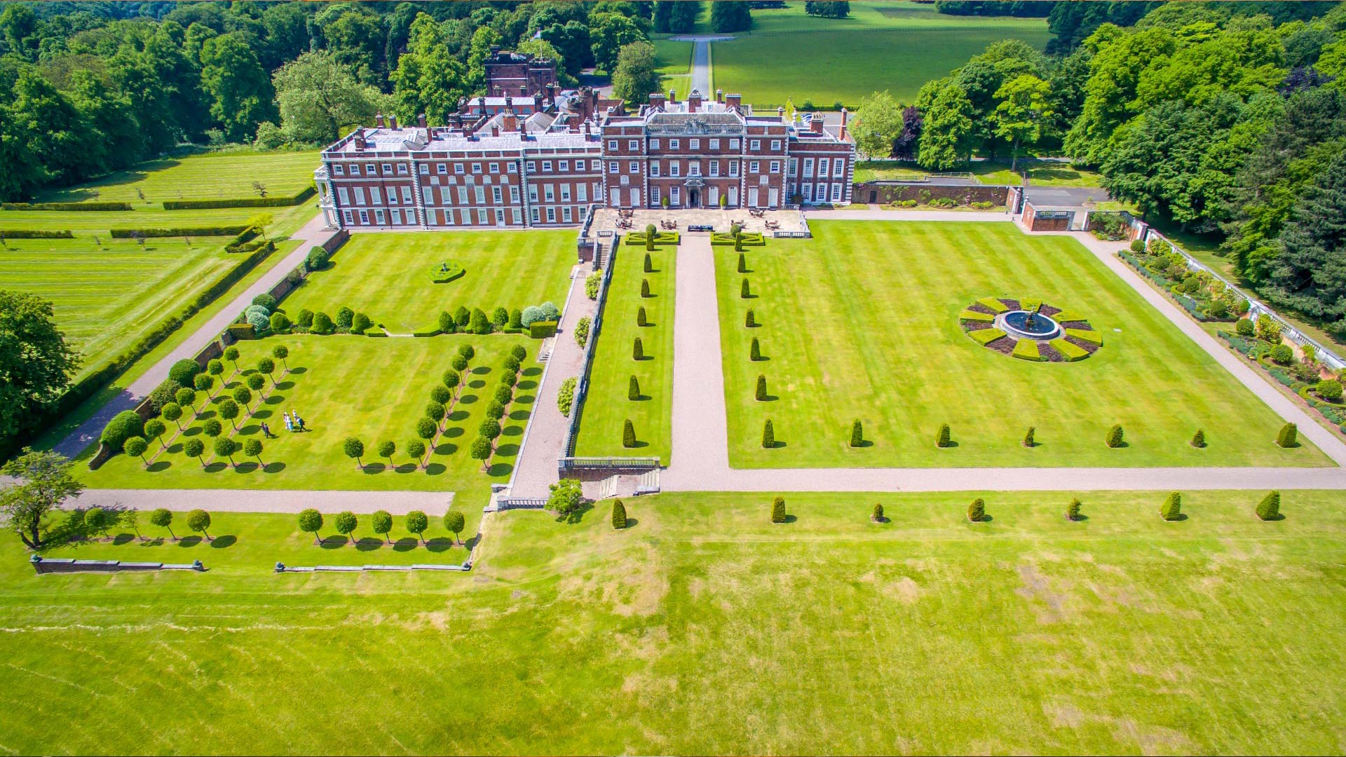 aerial-1920-web-legacy Birds eye view of huge manicured gardens and mansion house. Perfect for team building activities for a corporate away day.