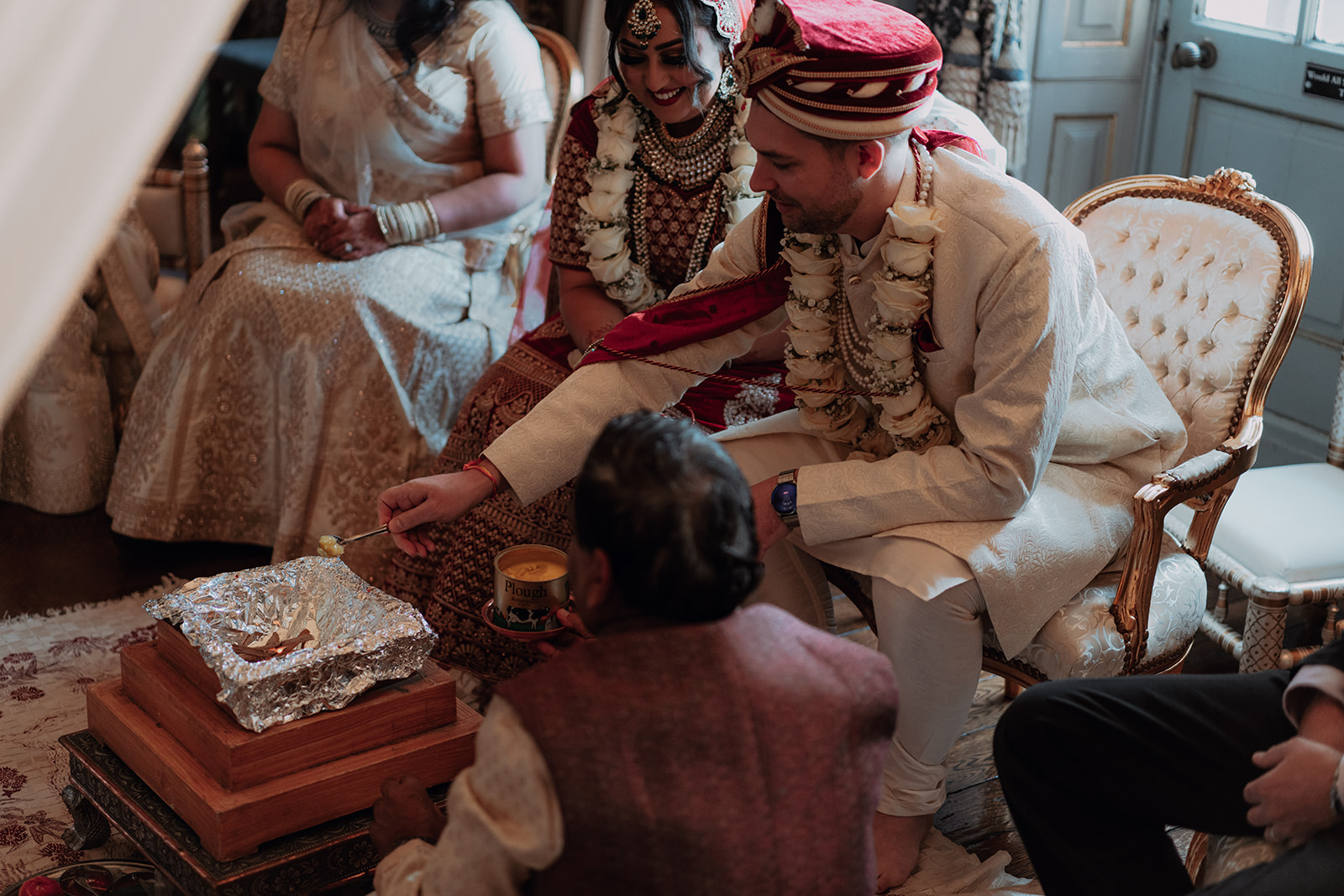A Hindu wedding couple having a fire sacred fire ceremony at Knowsley Hall