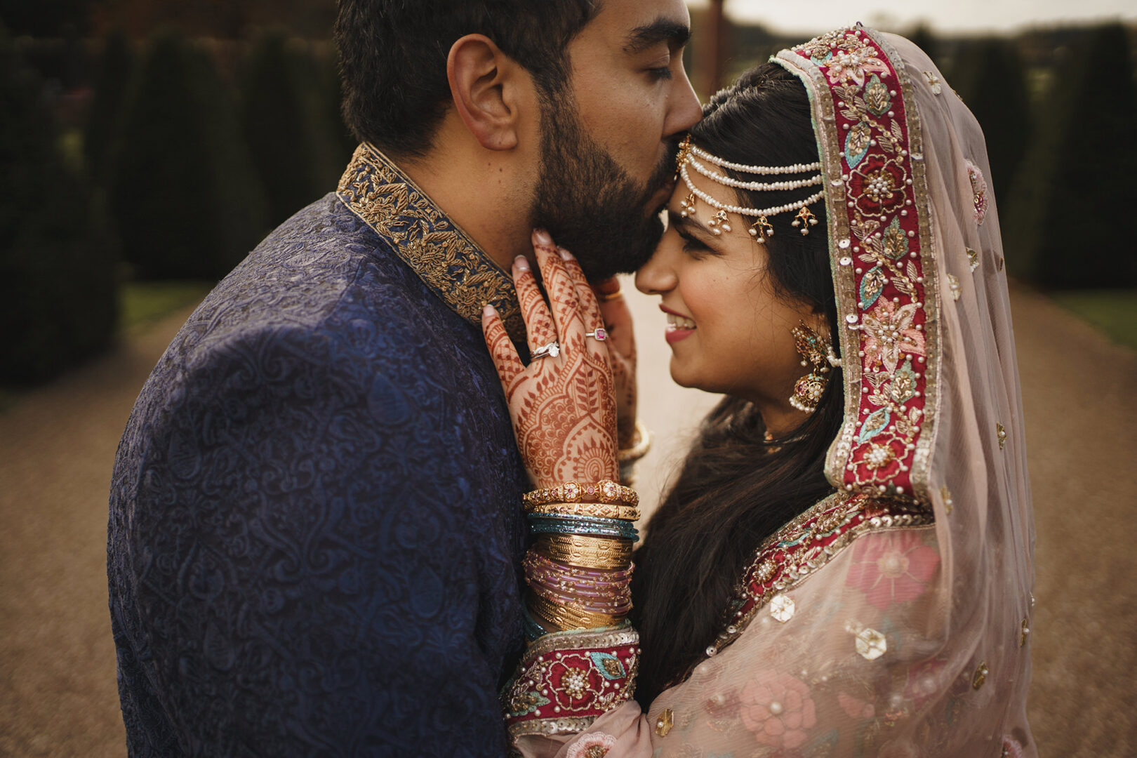 Indian Bride and Groom on their wedding day at Knowsley Hall. The Bride has painting of her hands called a mehndi