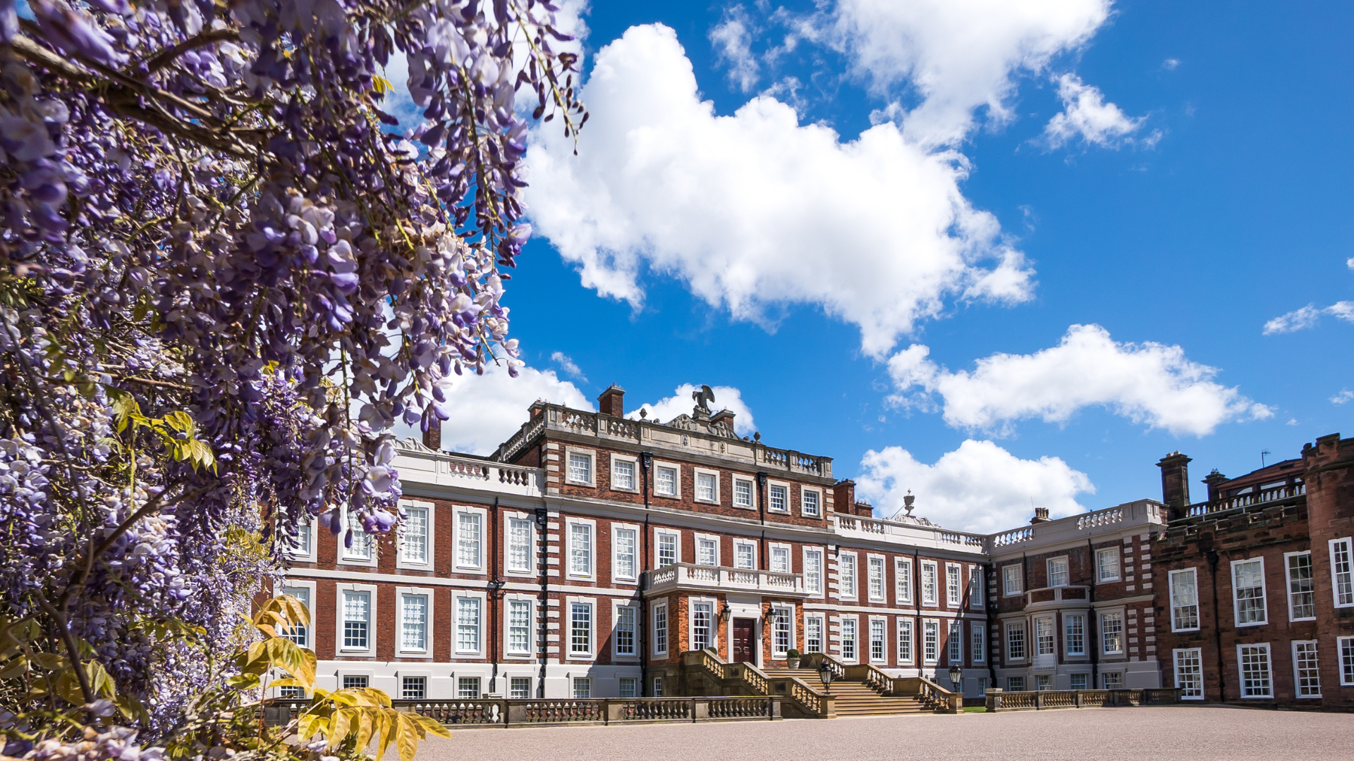 Knowsley Hall with blue skys and lilac flowers